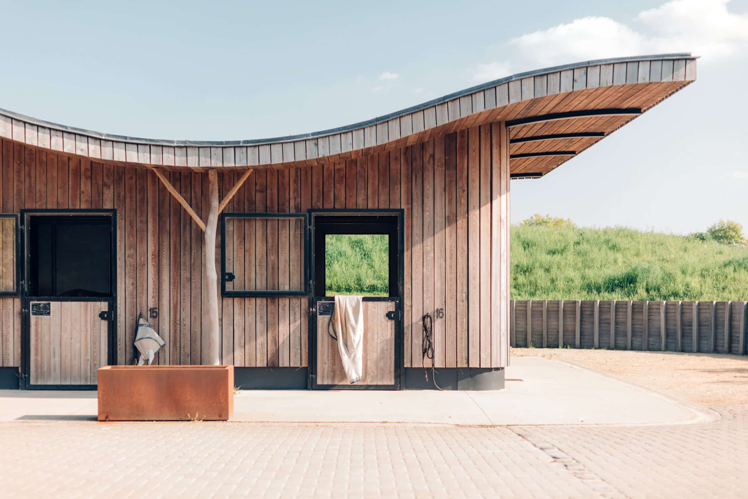 design stables in a horse education center modern horse farm with wooden and steel structures daylight